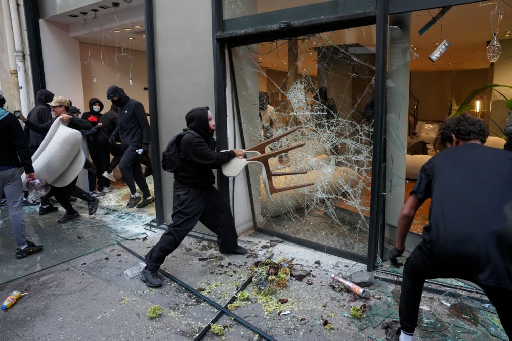 France curfews calm unrest as Macron faces criticism over Gulf trip